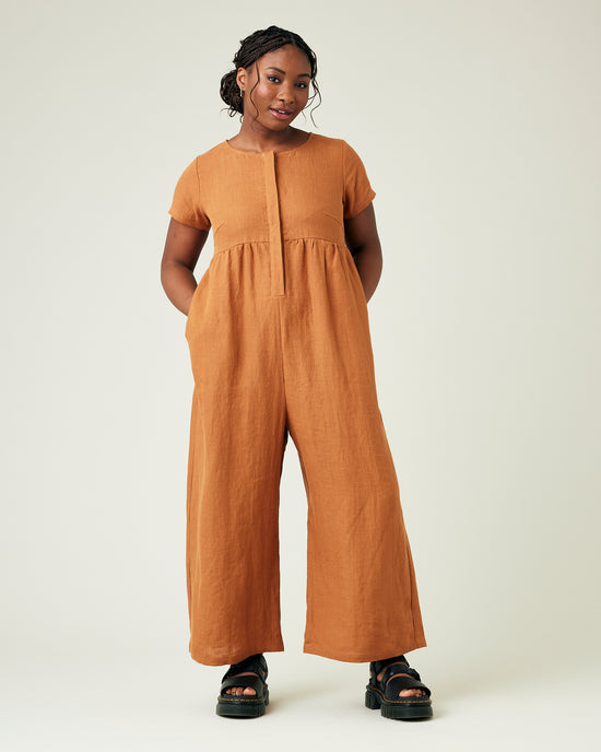 model wears rust linen sahara jumpsuit