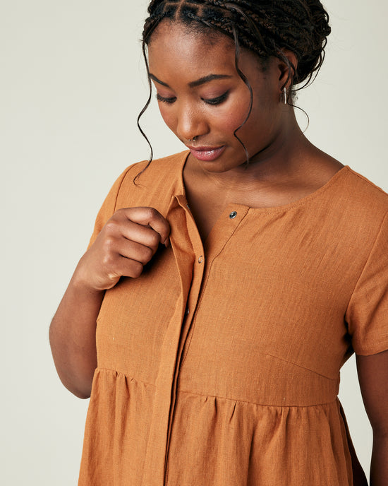 model wears rust linen sahara jumpsuit