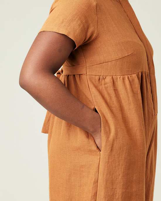 model wears rust linen sahara jumpsuit