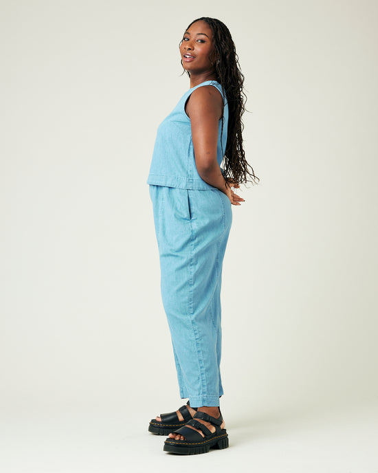 model wears light wash chambray mabel trousers