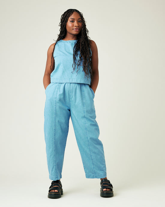 model wears light wash chambray mabel trousers