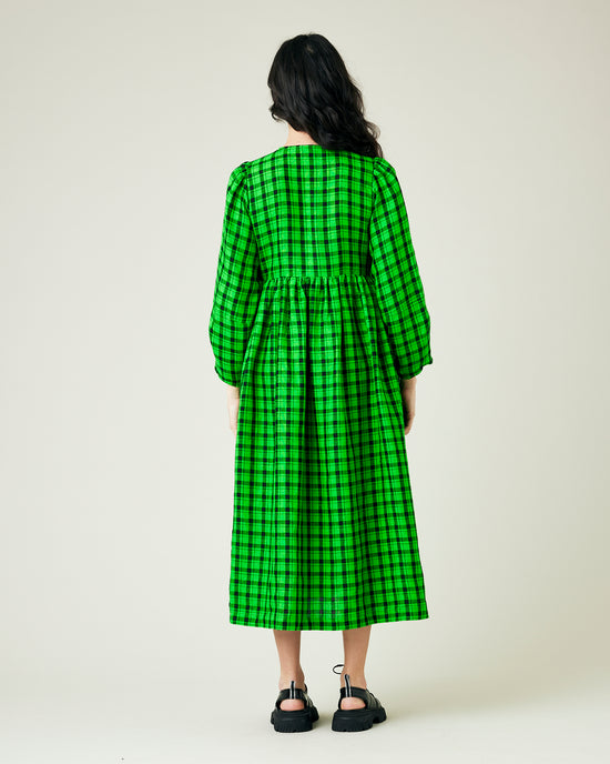 pregnant model wears green and black check linen isabel dress