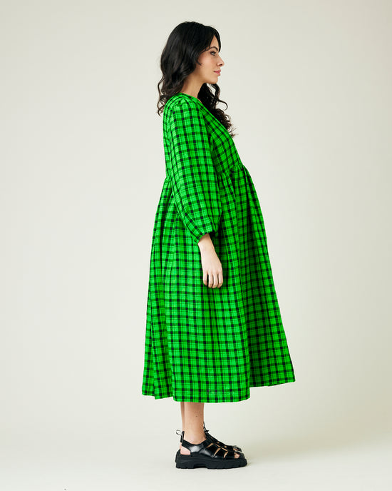 pregnant model wears green and black check linen isabel dress