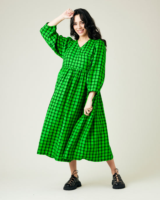 pregnant model wears green and black check linen isabel dress