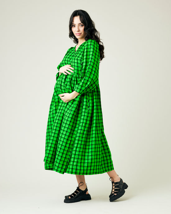 pregnant model wears green and black check linen isabel dress