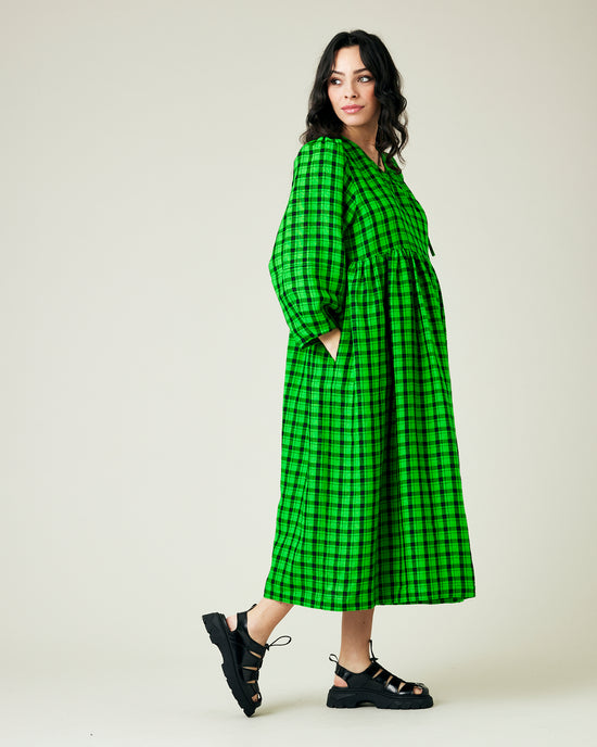 pregnant model wears green and black check linen isabel dress