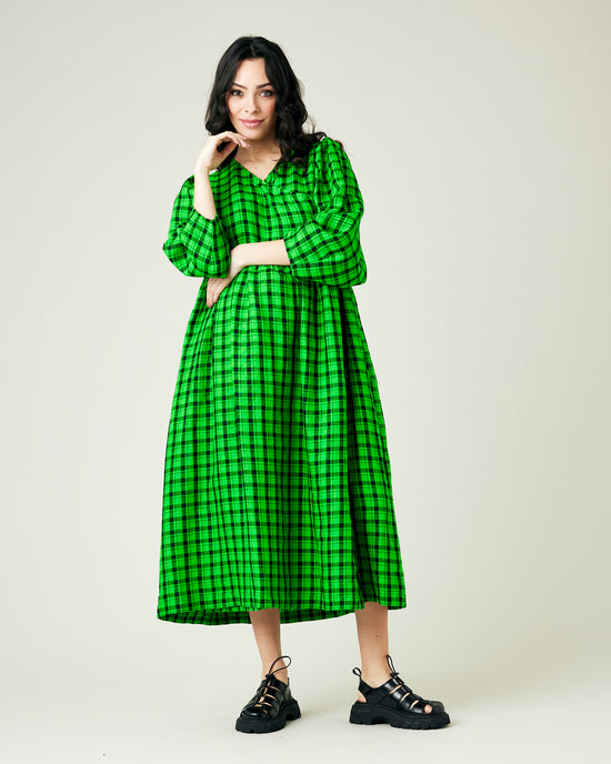 pregnant model wears green and black check linen isabel dress