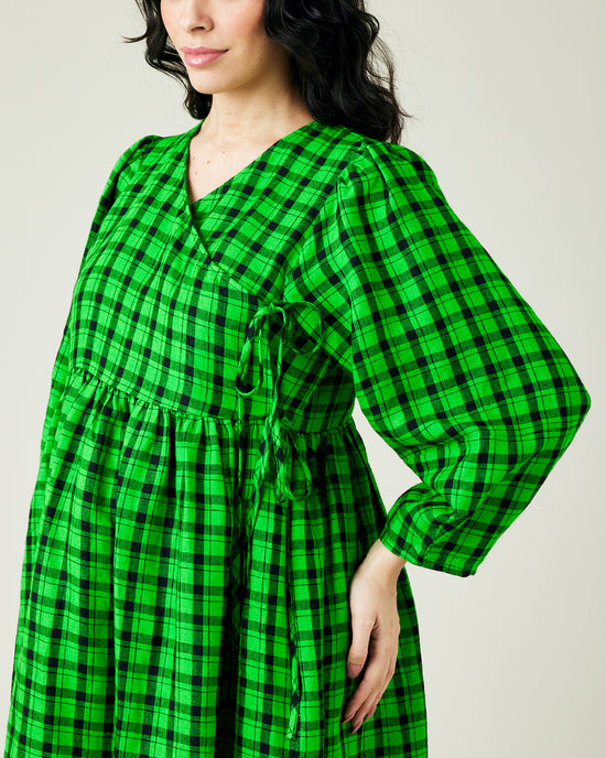 pregnant model wears green and black check linen isabel dress