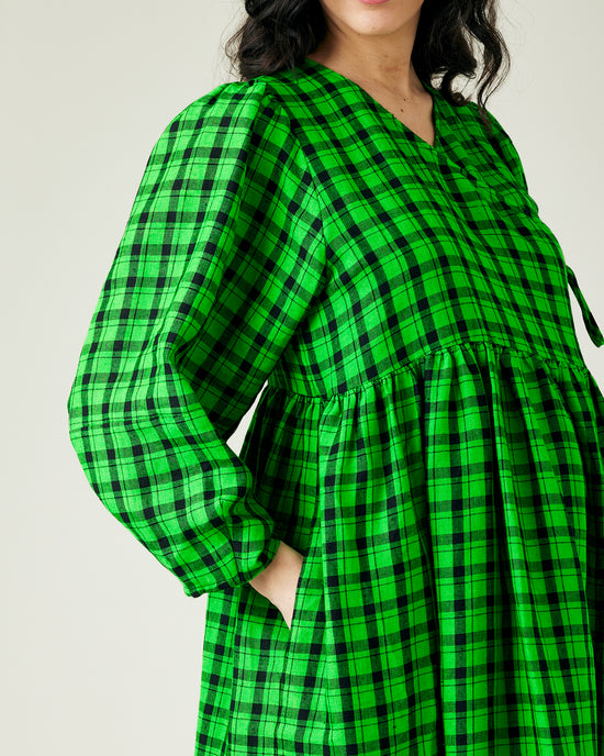 pregnant model wears green and black check linen isabel dress