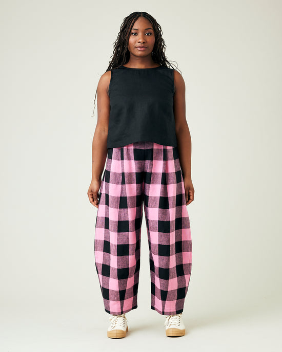 model wears daisy pink and black mega check linen trousers 