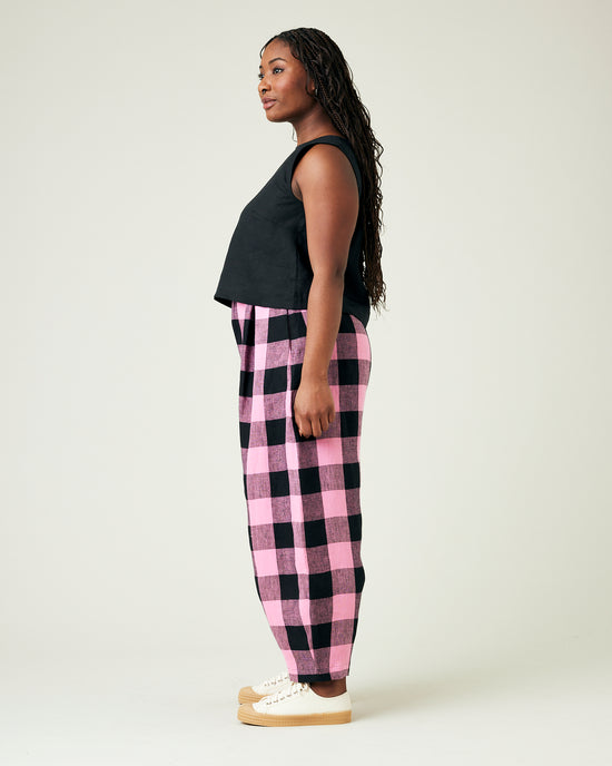 model wears daisy pink and black mega check linen trousers 