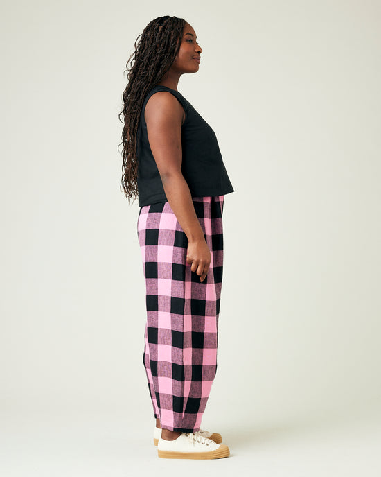 model wears daisy pink and black mega check linen trousers 