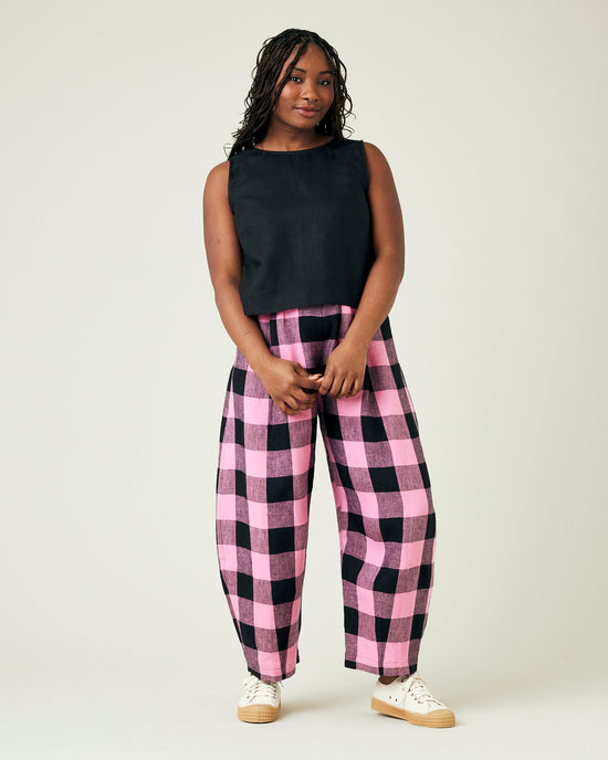 model wears daisy pink and black mega check linen trousers 