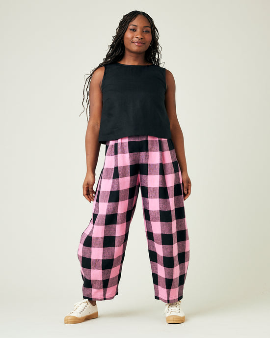 model wears daisy pink and black mega check linen trousers 