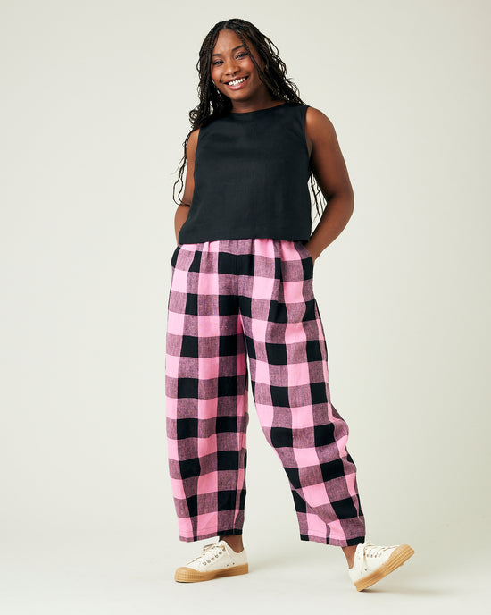 model wears daisy pink and black mega check linen trousers 