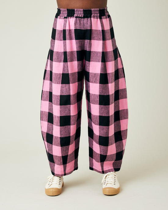 model wears daisy pink and black mega check linen trousers front