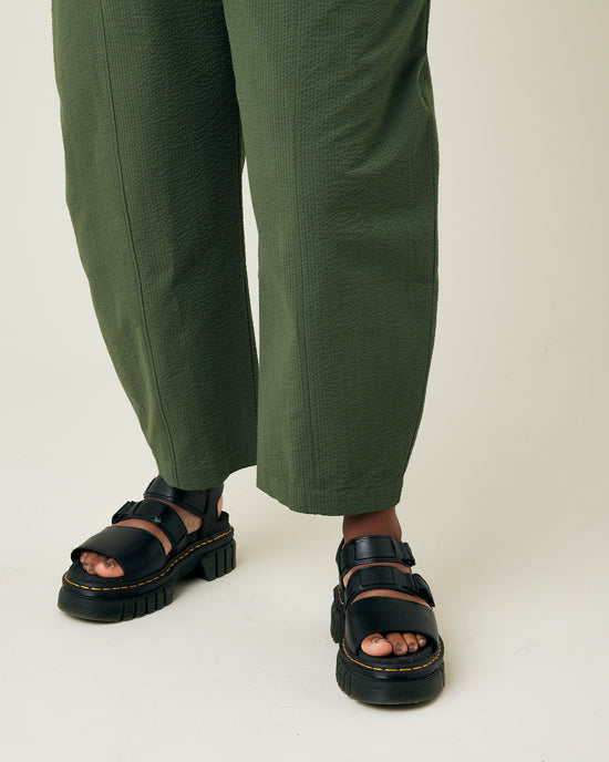 model wears khaki seersucker mabel trousers