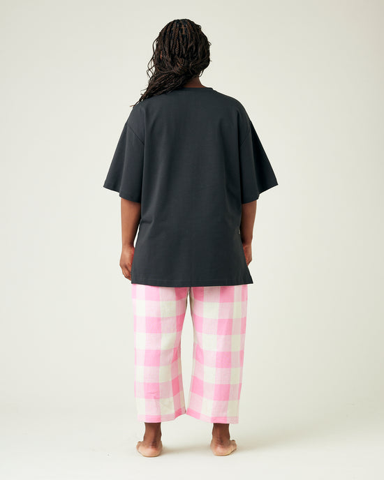 model wears pinks and ecru mega check ultimate pj linen trousers