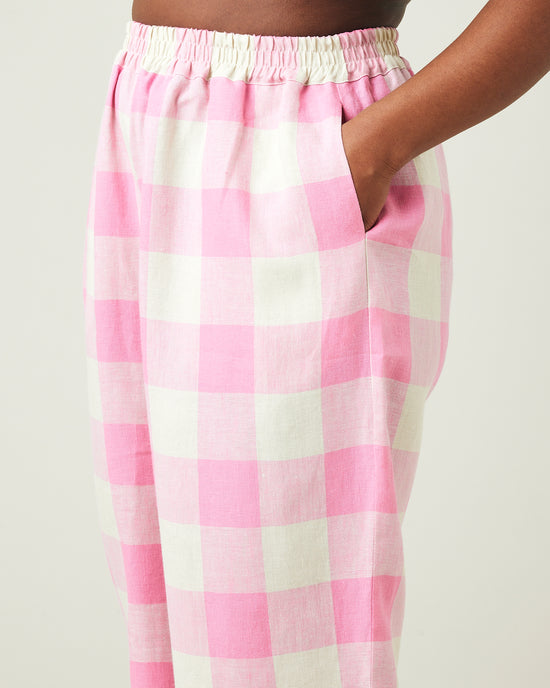 model wears pinks and ecru mega check ultimate pj linen trousers