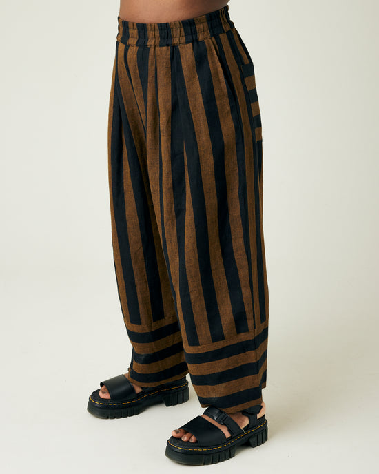 model wears rust stripe bobbi trousers left