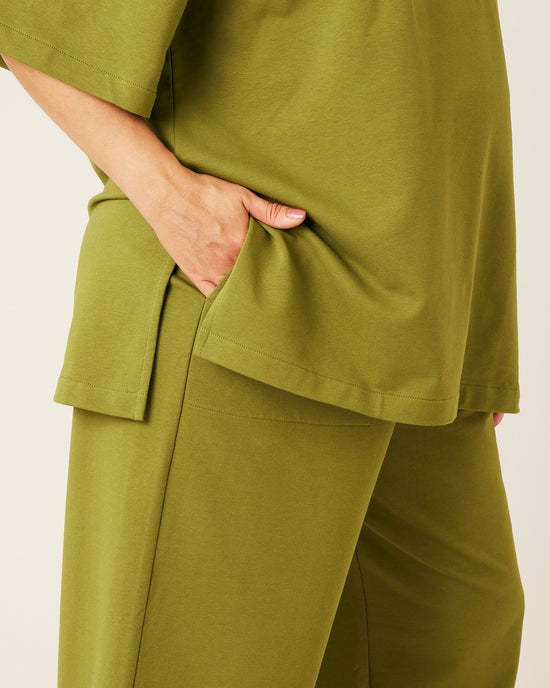 pregnant model wears moss green jersey huxley trousers