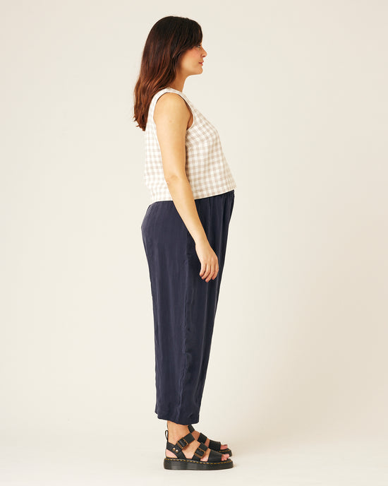 pregnant model wears navy cupro mabel trousers