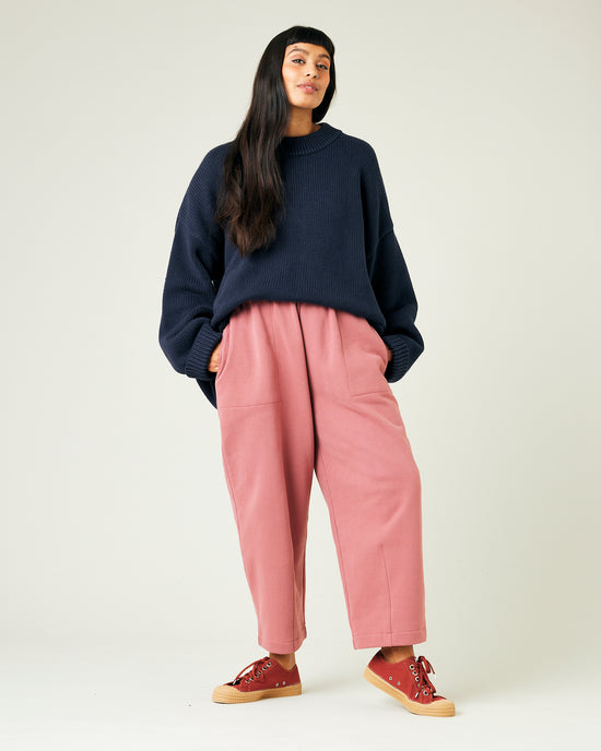 model wears dusty pink fleece jersey trousers