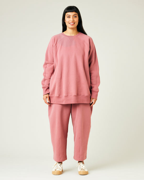 model wears dusty pink fleece jersey trousers