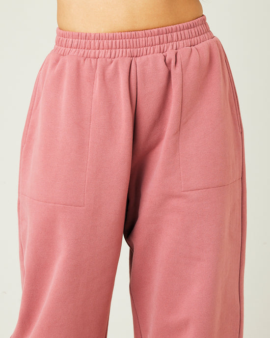 model wears dusty pink fleece jersey trousers