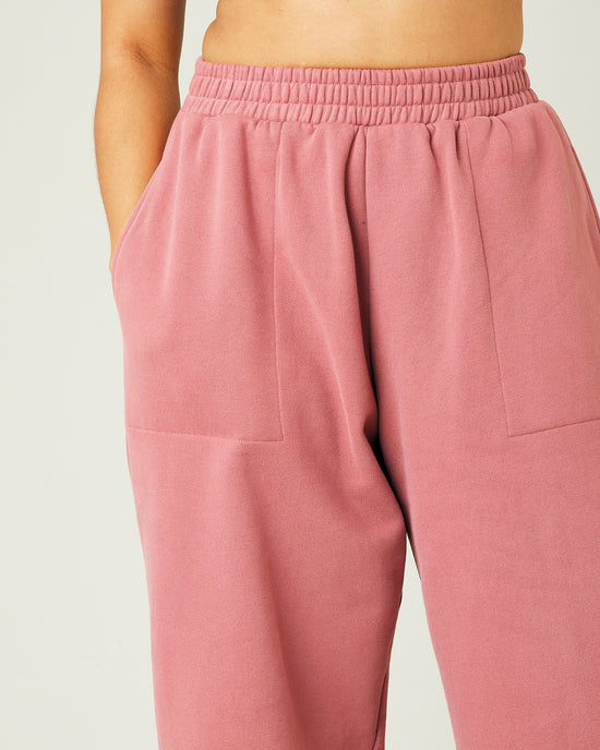 model wears dusty pink fleece jersey trousers