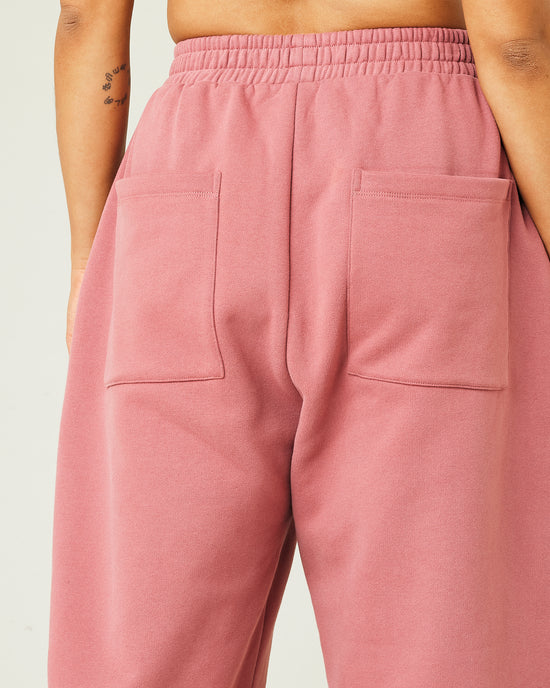 model wears dusty pink fleece jersey trousers