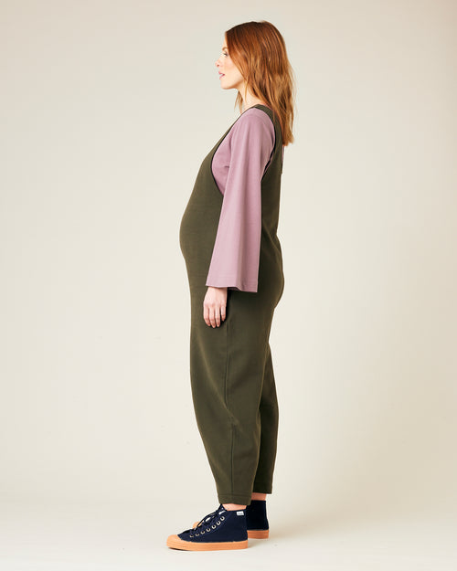 pregnant model wears olive jersey clover jumpsuit