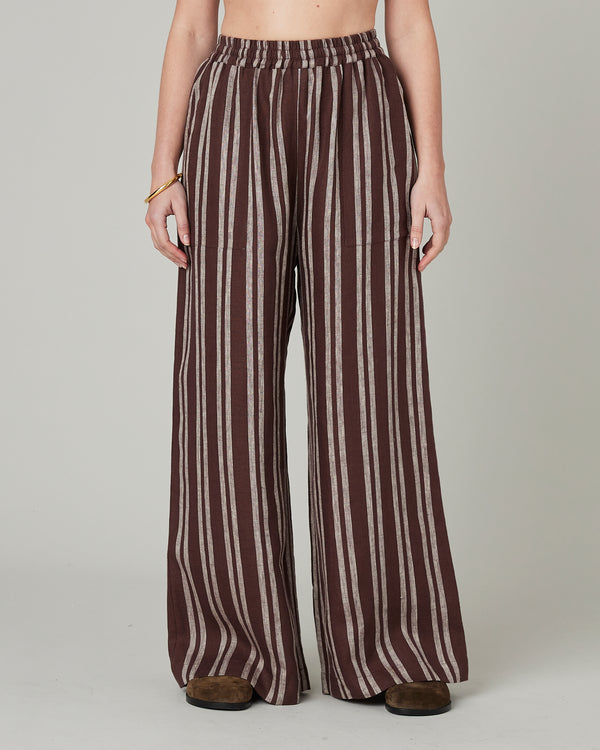 model wears coconut stripe linen lexi trousers front