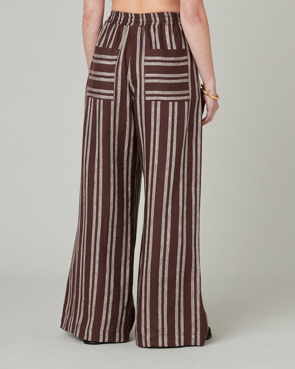 model wears coconut stripe linen lexi trousers back