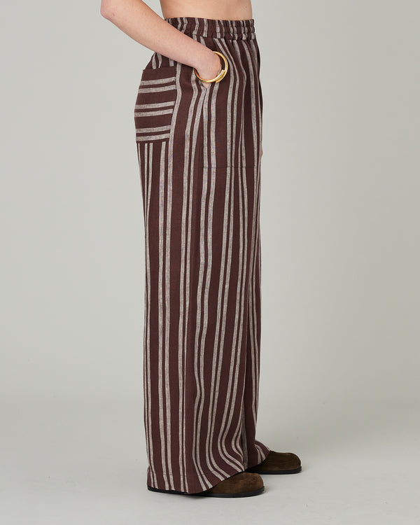 model wears coconut stripe linen lexi trousers right