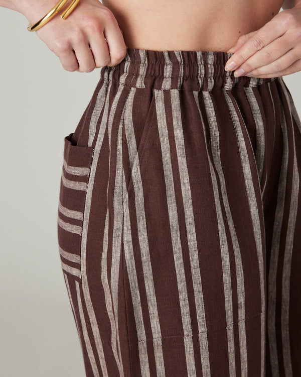 pregnant model wears coconut stripe linen lexi trousers