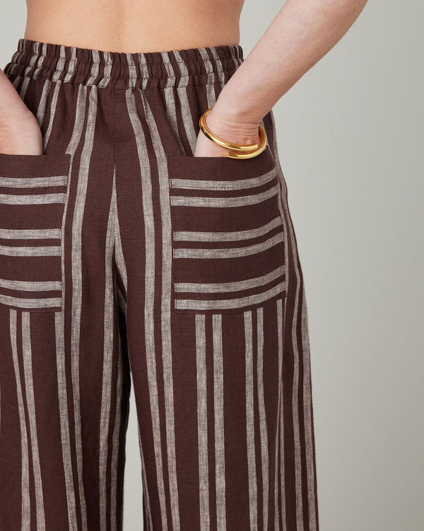 pregnant model wears coconut stripe linen lexi trousers