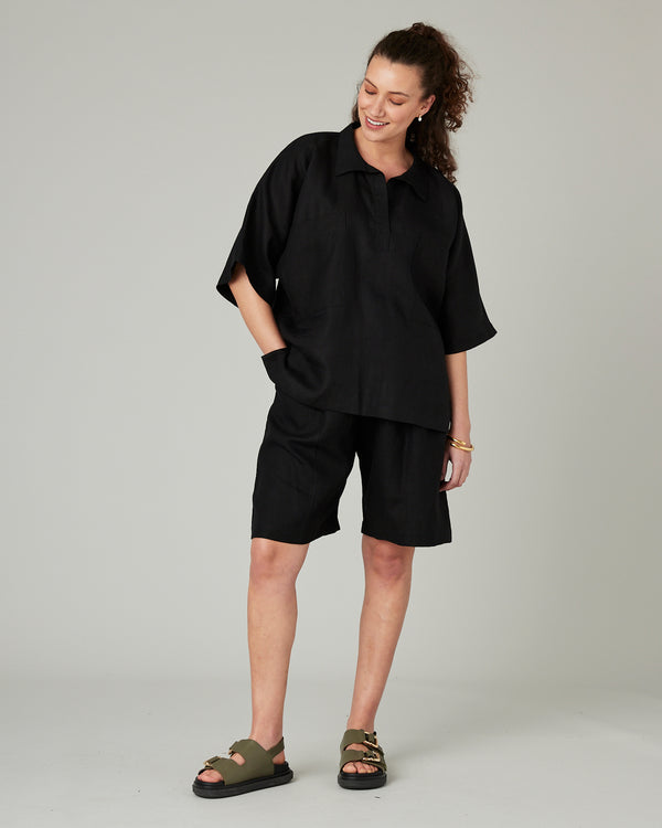 pregnant model wears black linen cara shirt 