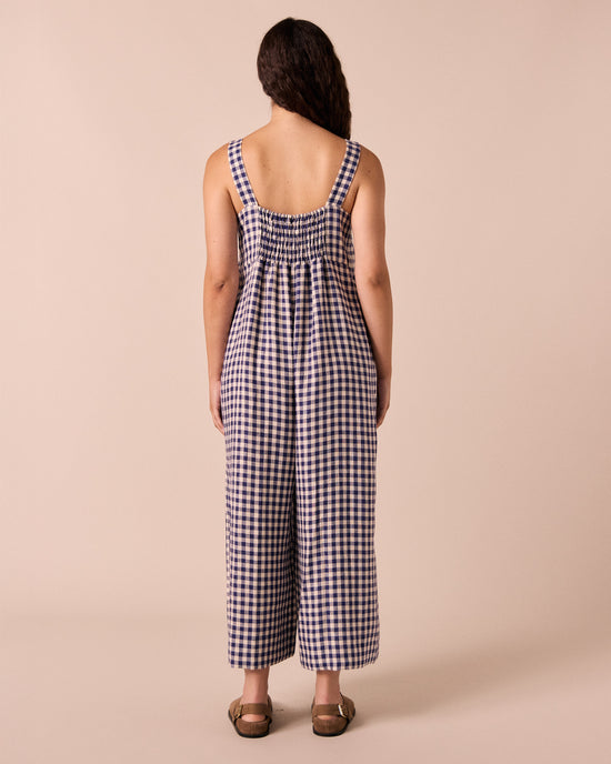 model wears cari indigo gingham linen jumpsuit