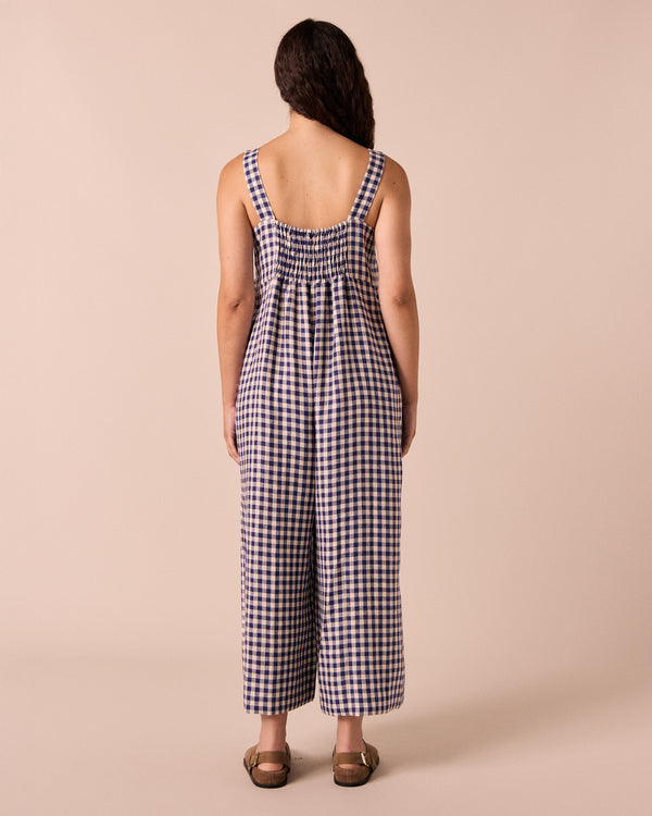 model wears cari indigo gingham linen jumpsuit