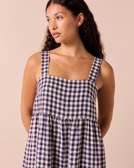 model wears cari indigo gingham linen jumpsuit