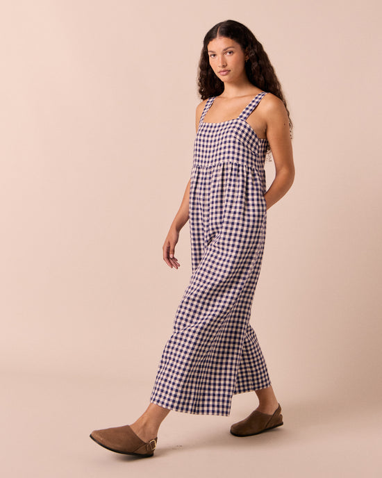 model wears cari indigo gingham linen jumpsuit