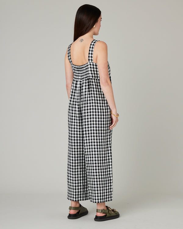 model wears black and white gingham cari linen jumpsuit