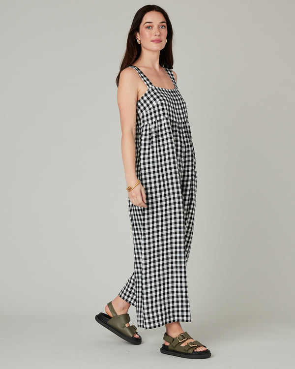 model wears black and white gingham cari linen jumpsuit