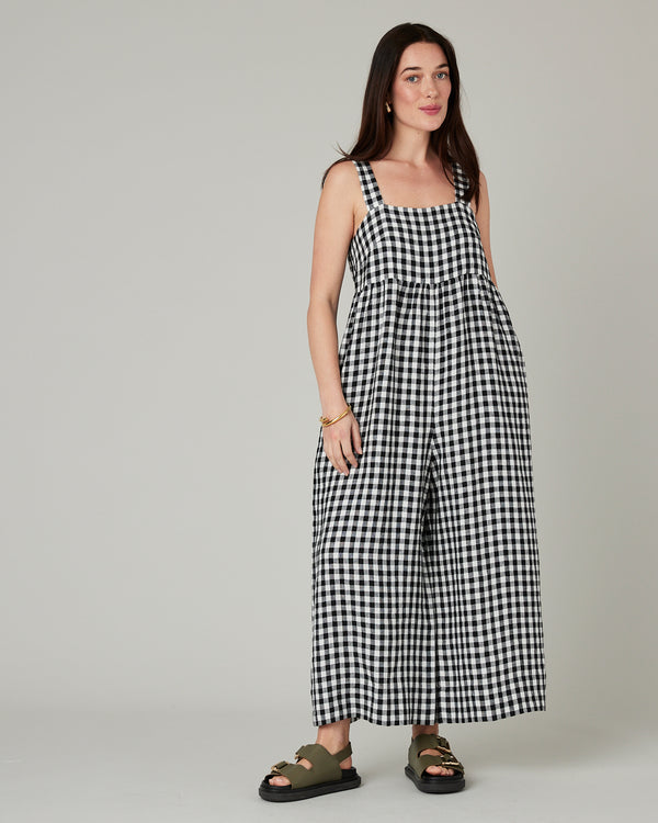 model wears black and white gingham cari linen jumpsuit