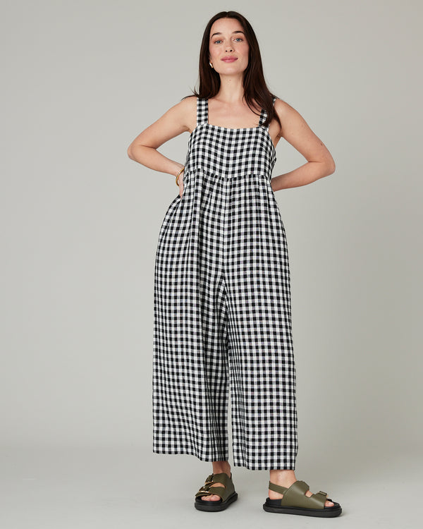 model wears black and white gingham cari linen jumpsuit