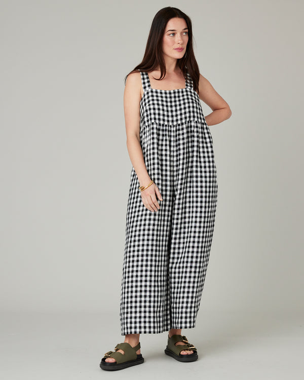 model wears black and white gingham cari linen jumpsuit
