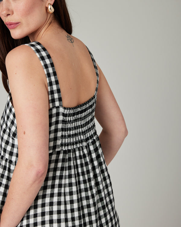 model wears black and white gingham cari linen jumpsuit