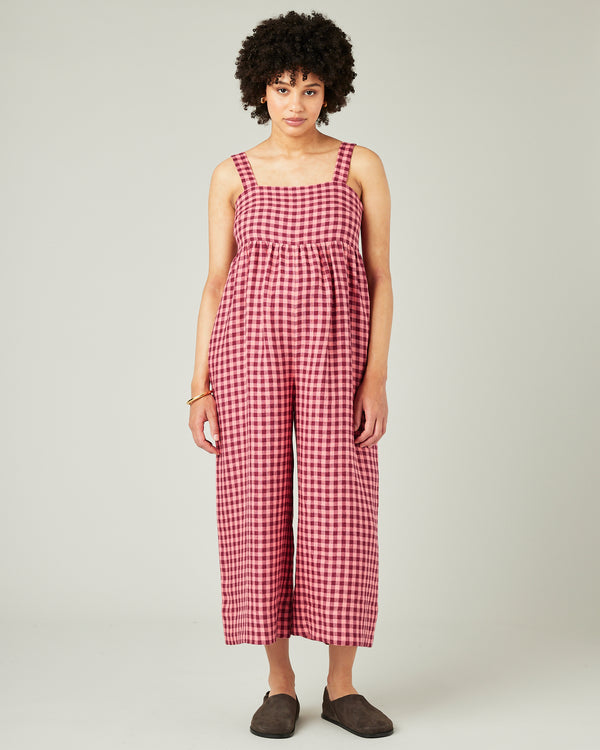 pregnant model wears blush gingham linen cari jumpsuit
