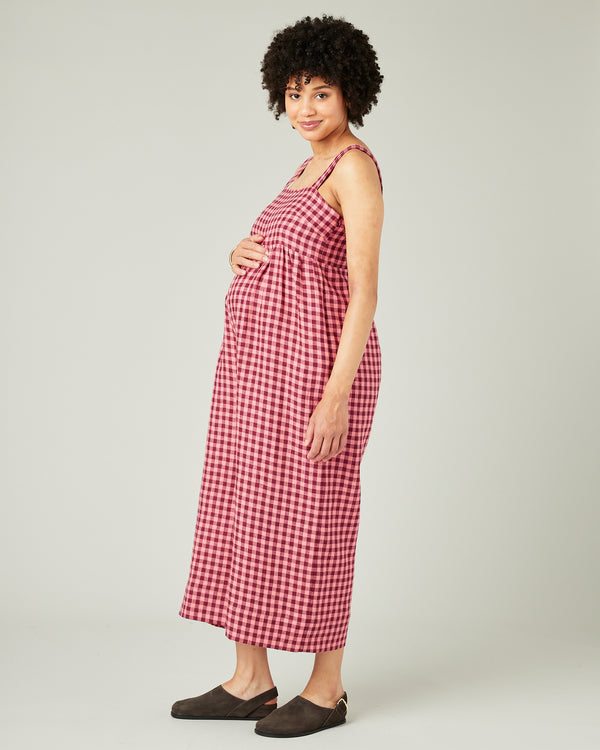 pregnant model wears blush gingham linen cari jumpsuit